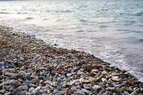 Rocks on the beach with a sea wave