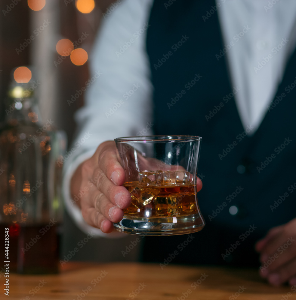 Barman pouring whiskey whiskey glass beautiful night celebrate whiskey on a friendly party in  restaurant