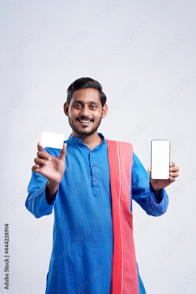 Young indian farmer showing card and smartphone on white background Young indian farmer showing card and smartphone on white background