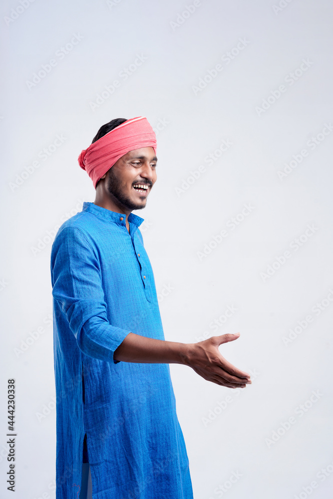 Young indian farmer giving expression on white background. Young indian farmer giving expression on white background.