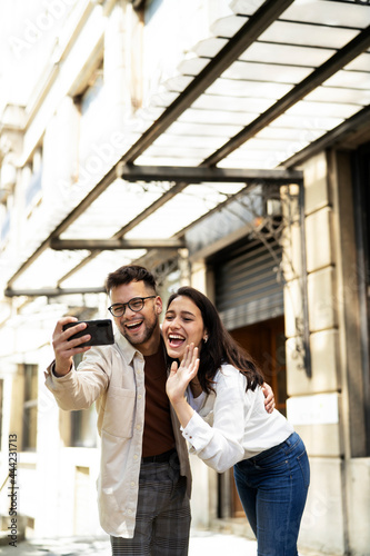 Happy young couple outdoors. Loving couple taking selfie photo. © JustLife