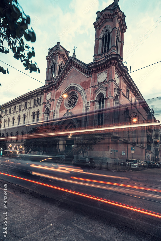 Cool long exposure cars traffic neon light trails, night view on the road, Rome, Italy. In front of Chiesa di Santa Maria Immacolata all'Esquilino