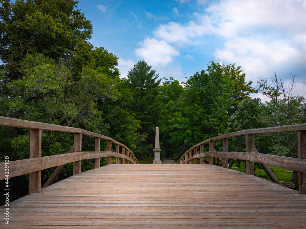 Old North Bridge at Minute Man National Historical Park in Concord, Massachusetts. Tranquil Nature Landscape over the Landmark Wooden Bridge.