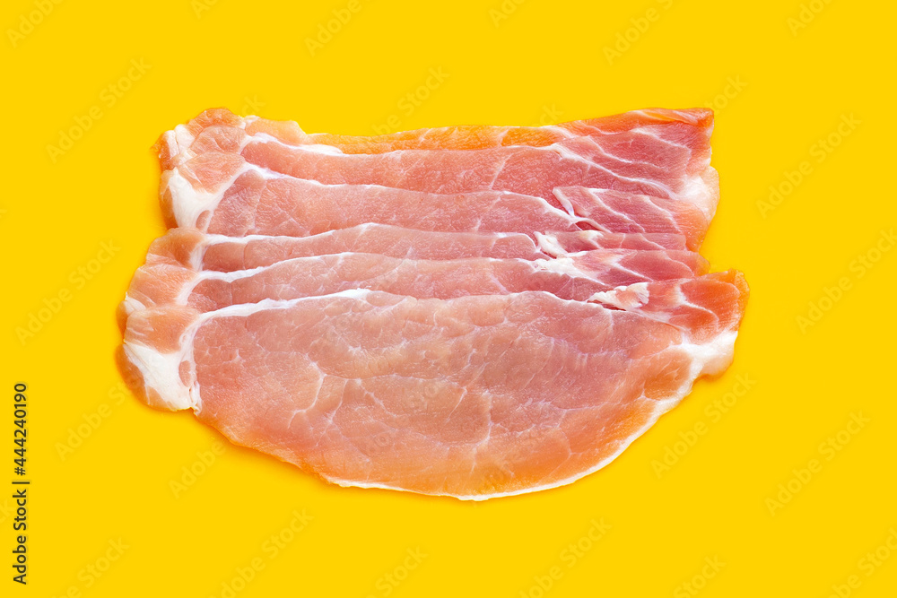 Sliced raw pork meat on yellow background. Sliced raw pork meat on yellow background.