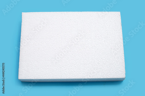 Sheet of foam on blue background. photo