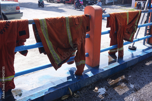 Fototapeta Naklejka Na Ścianę i Meble -  two wet fire jackets after use in the work and dried to be ready for use again