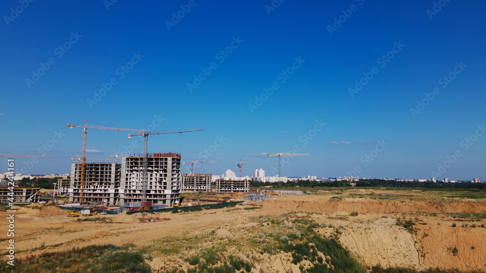 Modern urban development. Construction site with multi-storey buildings under construction. Construction of a new city block. Aerial photography.