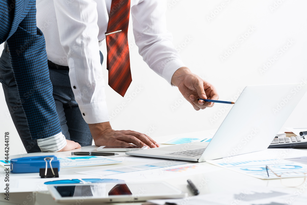 Businessman and businesswoman stand near desk Businessman and businesswoman stand near desk