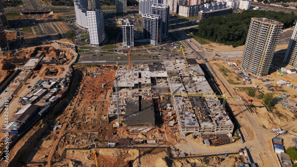Fototapeta premium Modern urban development. Construction site with multi-storey buildings under construction. Construction of a new city block. Aerial photography.