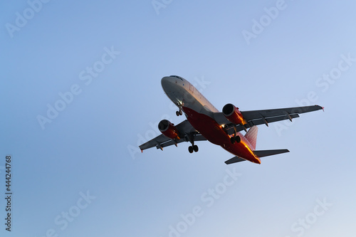 The plane comes in for landing at sunset