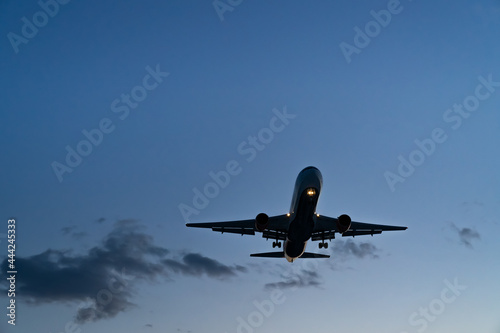 The plane comes in for landing at sunset