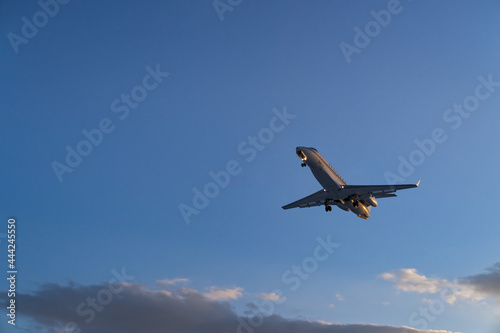 The plane comes in for landing at sunset