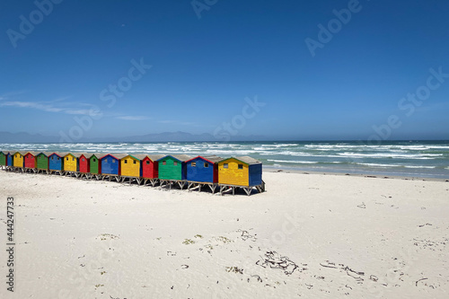 Famous colorful beach houses in Muizenberg near Cape Town, South Africa with Hottentots Holland mountains in the background. photo