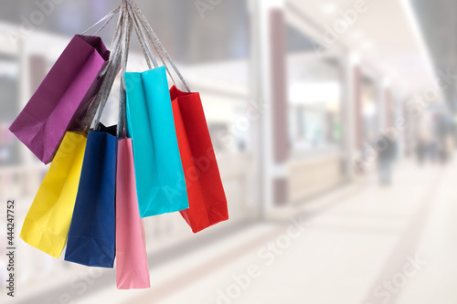 many colorful shopping bags on the background of the shopping center. black Friday