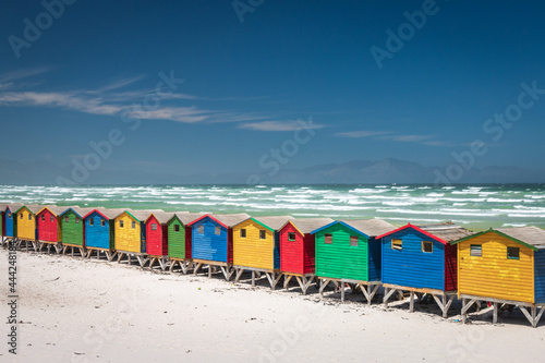 Famous colorful beach houses in Muizenberg near Cape Town, South Africa with Hottentots Holland mountains in the background. photo