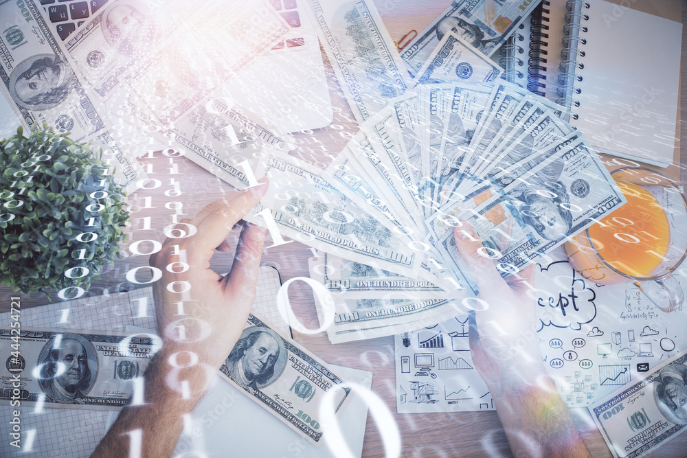 Multi exposure of technology drawing hologram and us dollars bills and man hands. Data concept Multi exposure of technology drawing hologram and us dollars bills and man hands. Data concept