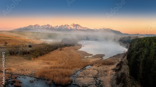 sunrise with fog by the pond below the Tatras