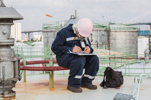 Male worker inspection roof storage tank