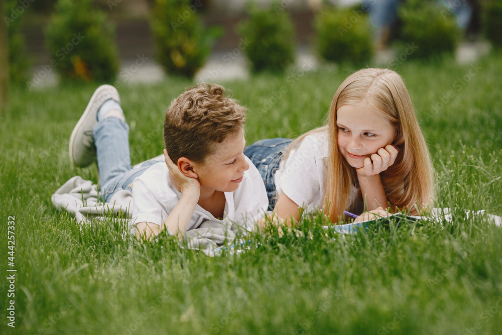 Happy children sitting together close and smile Happy children sitting together close and smile