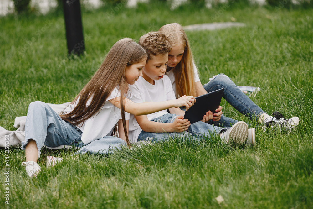 Happy children sitting together close and smile Happy children sitting together close and smile