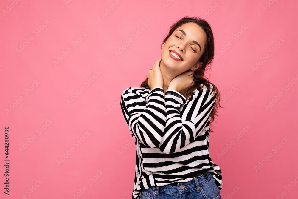 Photo portrait of young beautiful smiling hipster brunette woman in trendy pullover. Sexy carefree female person posing isolated near pink wall with empty space in studio. Positive model with natural Photo portrait of young beautiful smiling hipster brunette woman in trendy pullover. Sexy carefree female person posing isolated near pink wall with empty space in studio. Positive model with natural