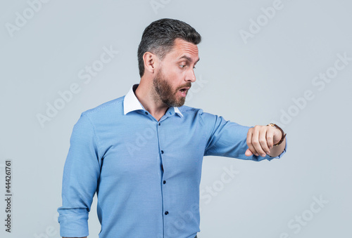 shocked businessman with hand watch. ceo man checking time. wristwatch on male hand.