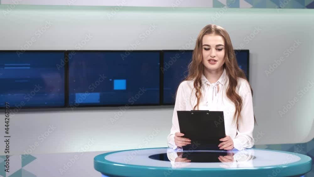 Young pretty tv presenter in studio before broadcasting