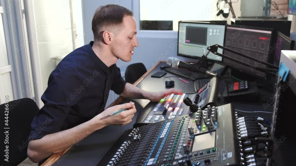 Sound engineer working in studio with equipment