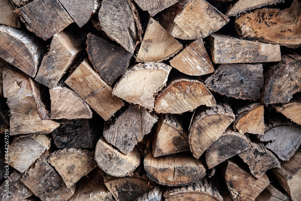 A chopped wood pile background with a well dried mix of hardwood and softwood ready for a winter fireplace.