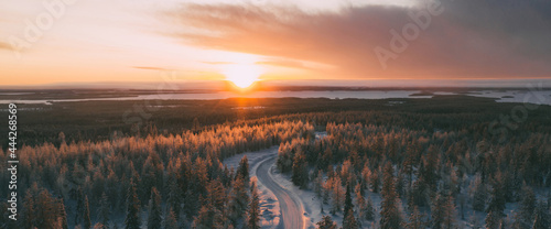 Aerial view from drone of snowy peaks of endless coniferous forest trees in Lapland National park environment, bird’s eye top view of natural landmark in Riisitunturi on winter season hidden in fog