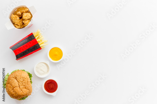 Fast food set. Hamburger and fries with sauces - takeaway