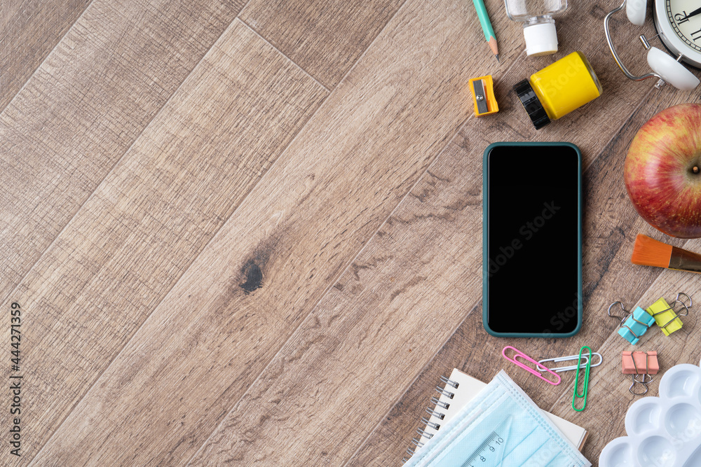 Back to school design concept with stationery over wooden table background.