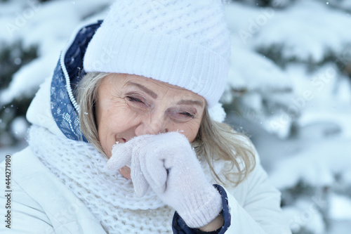 Happy beautiful senior woman in warm hat