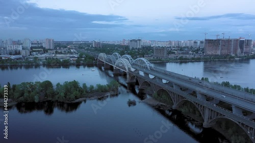 The camera flies over the iron bridges in the center of the river