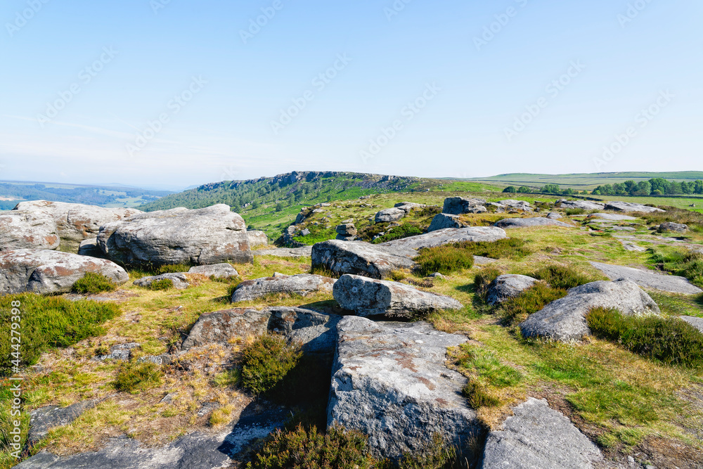 Gritstone rocks large and small scattered along the top of Baslow Edge