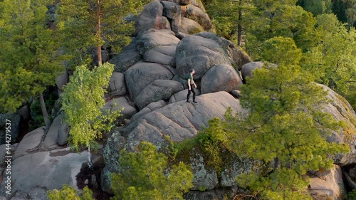 The traveler is climbing on the top of the wild mount The Krasnoyarsk Pillars