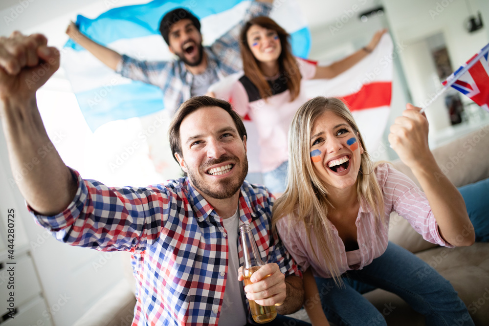 Cheerful and happy group of friends watching olympic games on tv. Cheerful and happy group of friends watching olympic games on tv.