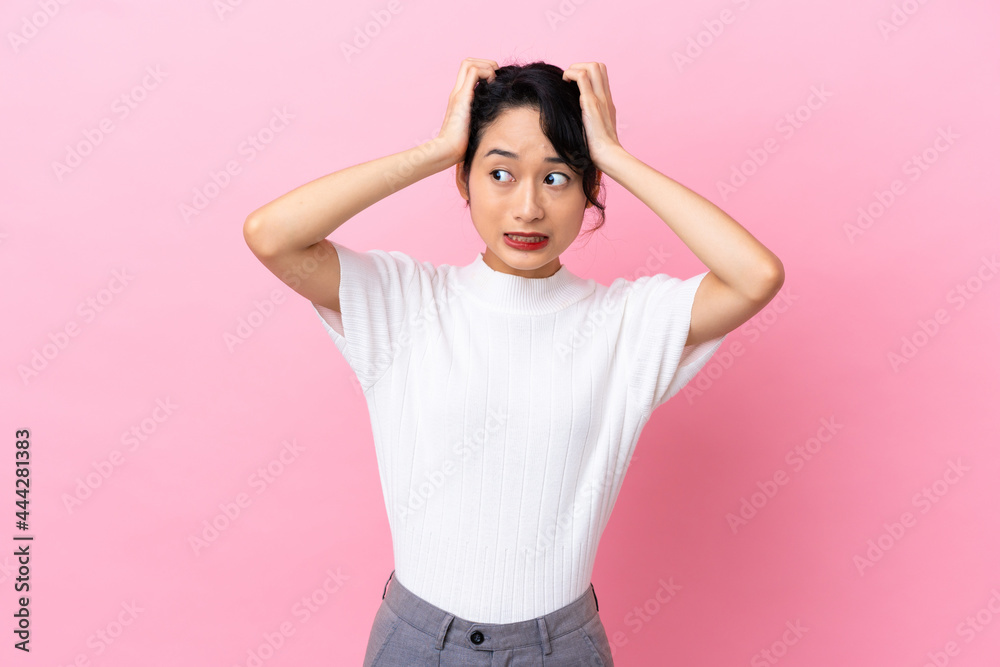 Young Vietnamese woman isolated on pink background doing nervous gesture Young Vietnamese woman isolated on pink background doing nervous gesture