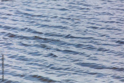 The smooth surface of the water in the lake as an abstract background.