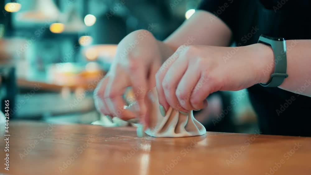 Close up of a dumpling getting shaped by a restaurant worker Close up of a dumpling getting shaped by a restaurant worker
