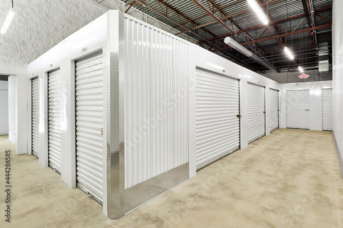 White storage containers in large industrial warehouse facility