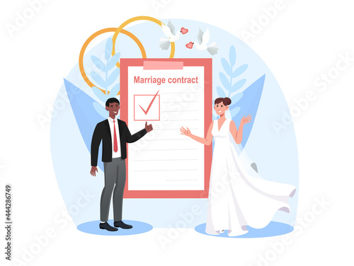 Smiling bride and groom are signing marriage contract together