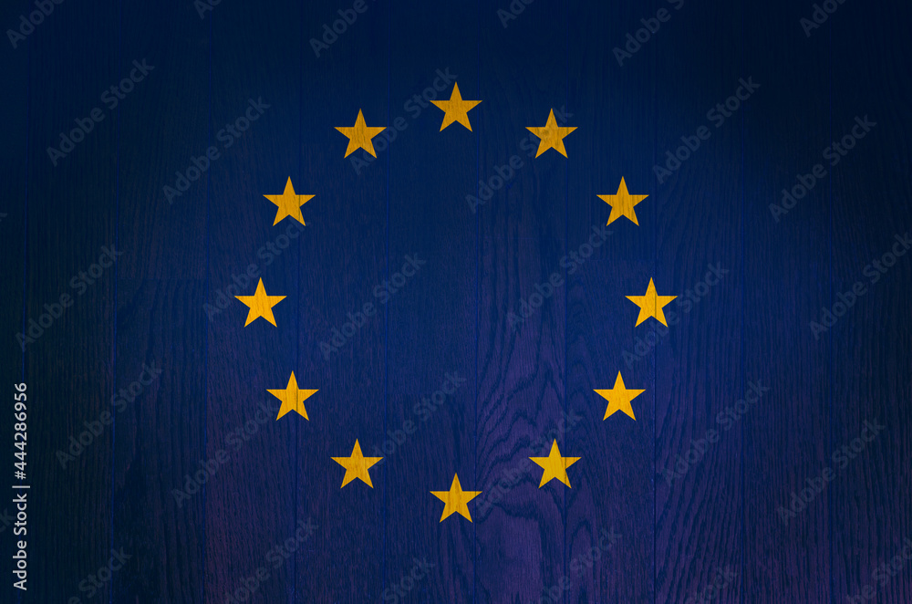 The flag of the European Union on a grunge wooden background. The flag of the European Union on a grunge wooden background.