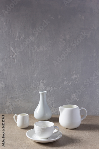 Empty crockery set or ceramic dishes. White kitchen dishware and tableware on table