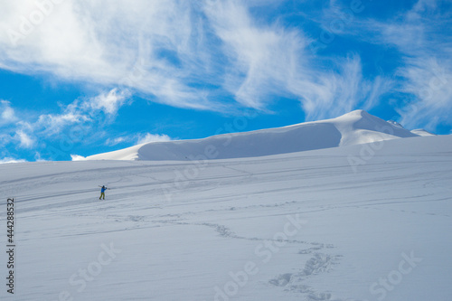 The image of a skier on a snowy mountain top.