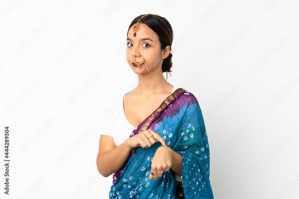 Young indian woman isolated on white background making the gesture of being late Young indian woman isolated on white background making the gesture of being late