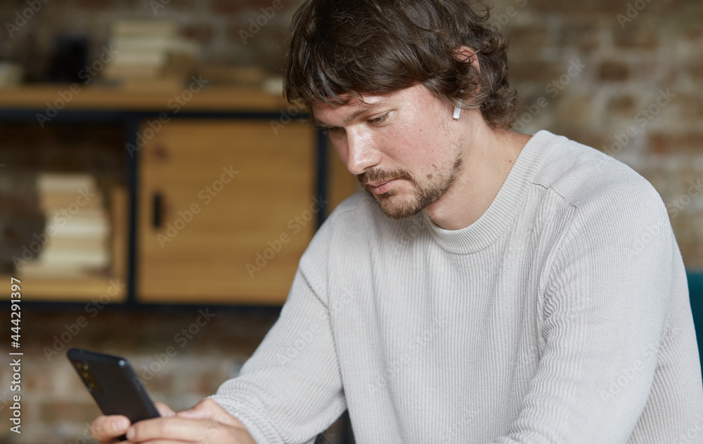 Relaxed man using mobile phone applications communicating in social network or shopping online, using smartphone scrolling social media swiping scrolling gestures, businessman enjoying success Relaxed man using mobile phone applications communicating in social network or shopping online, using smartphone scrolling social media swiping scrolling gestures, businessman enjoying success
