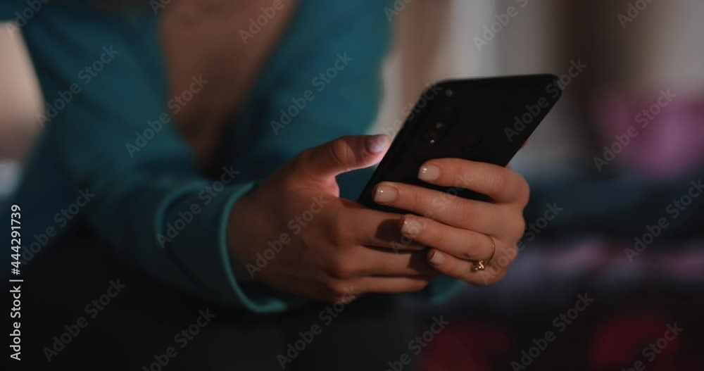 Female hands using smartphone at home Female hands using smartphone at home