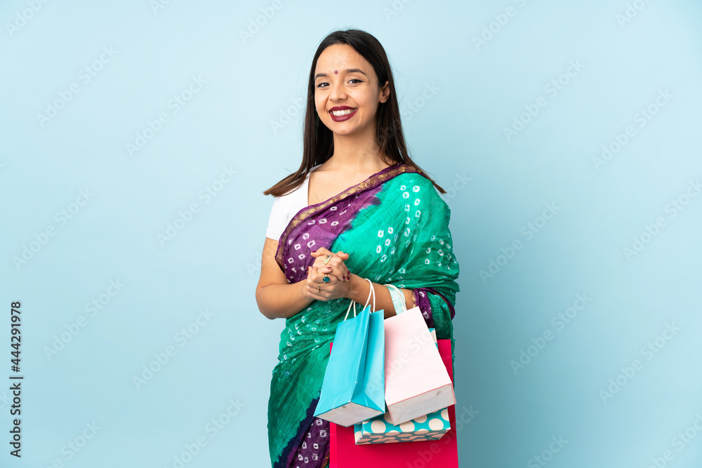 Young Indian woman with shopping bags laughing Young Indian woman with shopping bags laughing