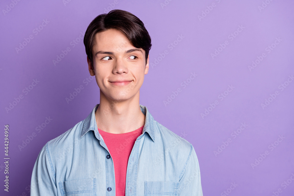 Photo of young handsome man happy positive smile curious look empty space isolated over violet color background Photo of young handsome man happy positive smile curious look empty space isolated over violet color background